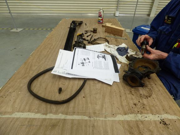 Using old manuals_Vauxhall_web Our Technical team using a tecnical manual of a Vauxhall car for conservaton work. Image: Air Force Museum of New Zealand.
