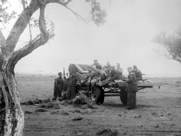 PR2183-R1-5-59 Salvage of Maritime Operational Conversion Unit Sunderland, NZ4111, after it was holed and sank in Te Whanga Lagoon, Chatham Islands. Members of the salvage party on a tractor's trailler.