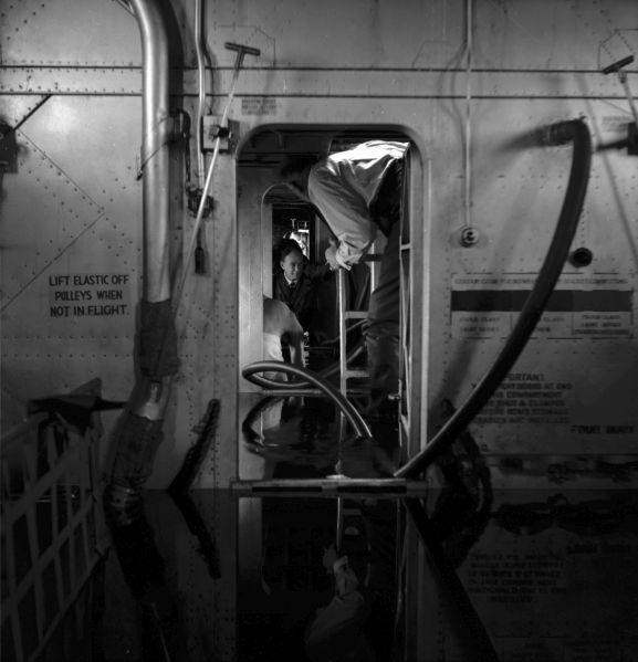 PR2183-R2-4-59 Salvage of Maritime Operational Conversion Unit Sunderland, NZ4111, after it was holed and sank in Te Whanga Lagoon, Chatham Islands. Personnel inside the flooded hull of the aircraft. NB. This negative deteriorating resulting in poorer image quality.