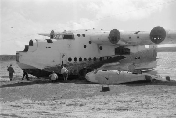 WhG1692-60 No. 5 Squadron Sunderland NZ4111 being salvaged for parts on the shore of Te Whanga Lagoon on the Chatham Islands.