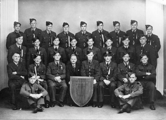 MUS0901732 Group. RNZAF Station Hamilton rugby team representatives for the JA Ward VC Memorial Shield. Beat Wanganui 9-0. L-R: Back; M Wharerau, EH Wilcox, LA Haughton, MJ McGrath, RH Bell, JR May, WA McArthur, AJL Jackson, DG Smith. Middle; RJ Avery, T Pritchard, TR Dick, HW Bellini, DJ Smith, L Cameron, S Florence, JC O'Connor. Front; J Moyle, GE Laing, OI Jacobsen (Vice-Captain), Mr. P Ward, J McDonald (Captain), CJ Keppel (Manager), J Rahmann (Coach), AG Bunn. In front; M Codlin, RC Warren. Absent; Wing Commander W Temple (Commanding Officer and Patron).