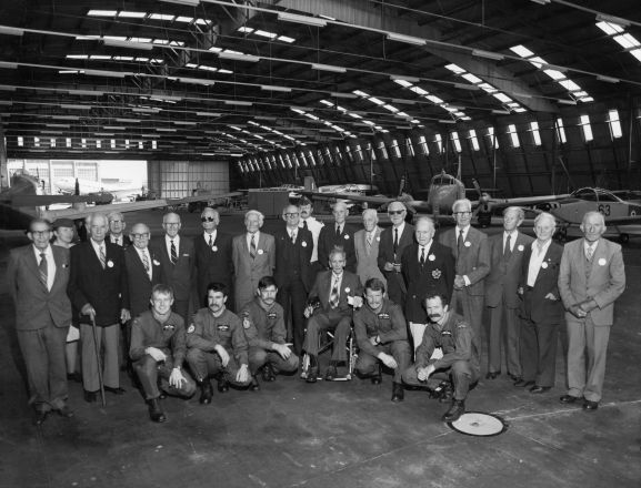 2019-064.19a Group of World War One airmen at the 1981 Reunion held at Wigram. Harry Leese is standing fifth from the right in the blazer with a badge. L-R: Standing; HW McFarlane (Christchurch), Flying Officer Lorraine Creighton, John Seabrook (Auckland), RN Munro (Napier), P Pattson (Auckland), CR Williamson (Christchurch), IE Rawnsley (Wellington), CJ Tapper (Gisborne), WW Withell (Christchurch), Leading Aircraftman M Cocker, AT Allen (Christchurch), Arthur PArrish (Auckland), Reg Kingsford (Nelson), HC Leese (Auckland), Harry Walker (Nelson), Eric Flower (Nelson), Tom Leighs (Christchurch), Bill MacPherson (Wanaka). Front; Flight Lieutenant CF Pearce, Flight Lieutenant RS Ginders, Flight Lieutenant FH Parker, A Cassie (New Plymouth)(seated), Flight Lieutenant RA Jannesen, Squadron Leader JS Bates. Absent (but attended reunion); EW Reeves (Christchurch), HG Eldon (Nelson), D Checkley (Blenheim), JF Winn (Wellington).