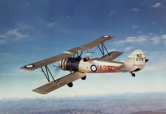 OhC394-85 Air to air view of Avro 626 NZ203 in flight over hills after being fully restored.