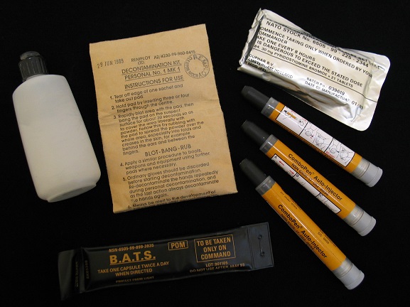 1992-054-5 Personal NBC (Nuclear/Biological/Chemical) Warfare Kit, issued to Warrant Officer Pat MacKay during the 1991 Gulf War. Kit consists of olive green carry case containing: rubber gloves with cotton inners; three