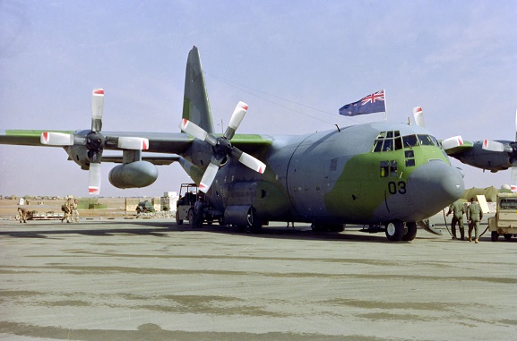 PD29-10-91 No. 40 Squadron Hercules NZ7003 with a New Zealand flag flying from the cockpit hatch. Presumed to be at King Khalid International Airport, Riyadh, Saudi Arabia, Feb-Mar 1991. Image ref PD29-10-91, RNZAF Official.
