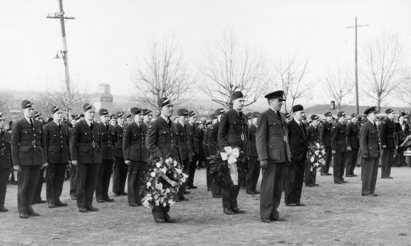 servicemen-at-service-holding-flowers